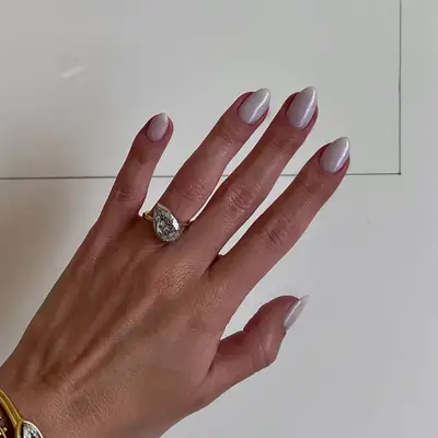 A short milky white manicure topped with chrome