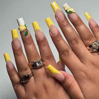 A yellow French manicure with 3D lemon accents