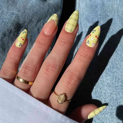 A plaid and fruit yellow French manicure