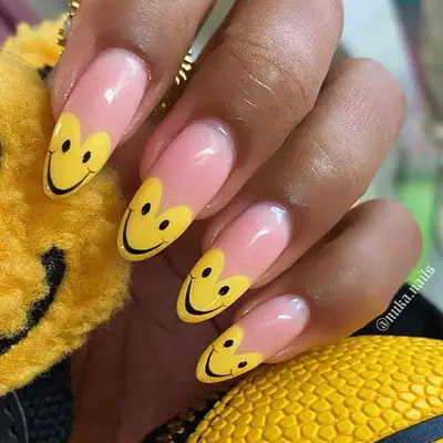 A French manicure with yellow, heart-shaped tips