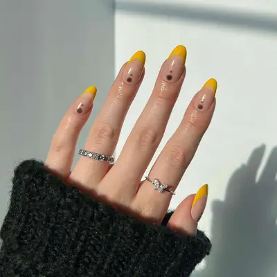 A dotted yellow French manicure 