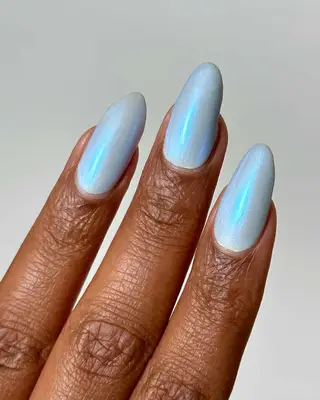 Black woman with icy blue iridescent nails
