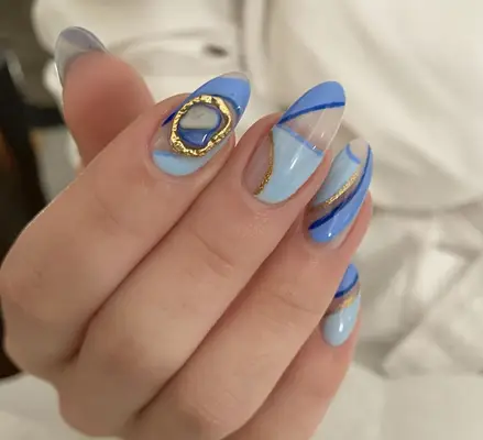 Almond shaped nails with baby blue geometric print nail art