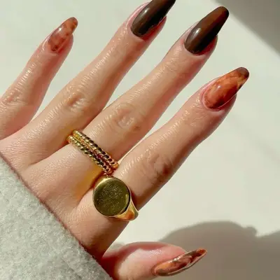 Sheer marbled coffee manicure on long square tips 