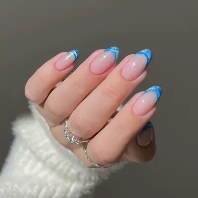 Blue marbled French manicure on oval nails 