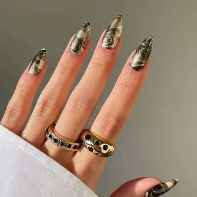 Metallic slate and champagne marbled almond-shaped nails