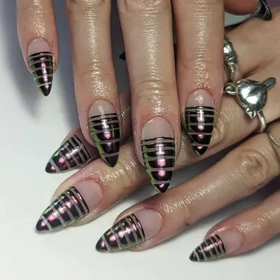a manicure with dark chrome stripes