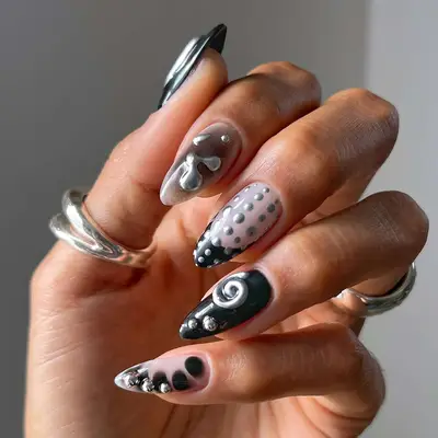 a mismatched manicure in black and nude, topped with 3D silver chrome accents