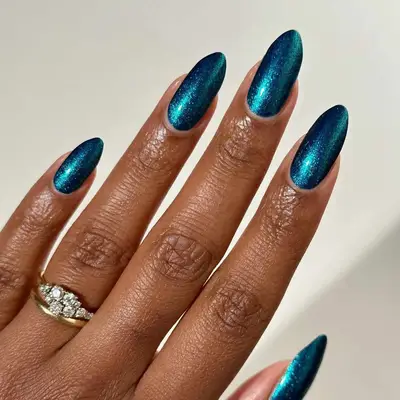 a teal metallic manicure