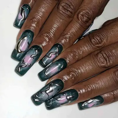 a black and pink aura manicure with 3D silver accents