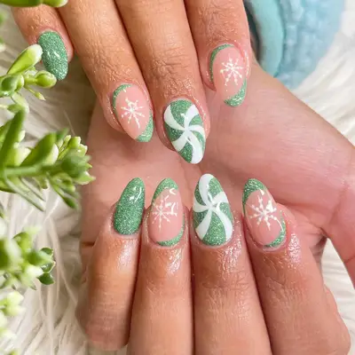 manicure with sparkly green christmas nails with snowflakes