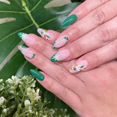 manicure with green christmas nails with snowflakes, holly, etc