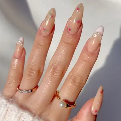 Hand with decorated fingernails, wearing rings on fingers