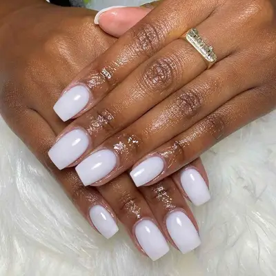 A milky-white dip powder manicure