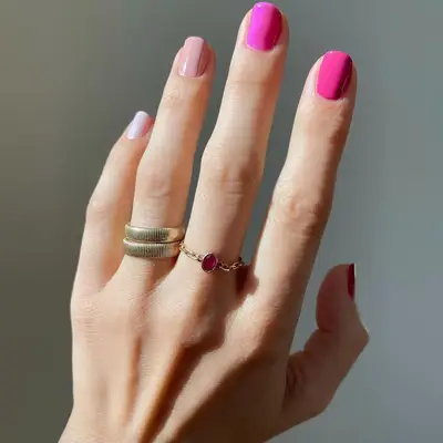 Hand Wearing Winter Nail Colors in Hot Pink