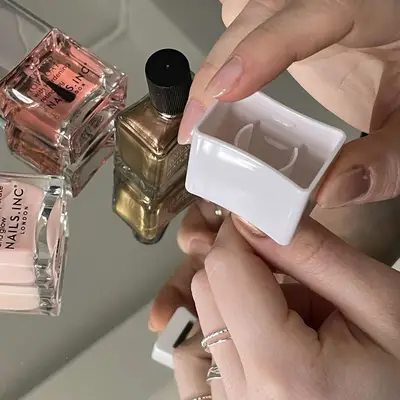 A painted finger with a magnet hovering over it