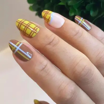 Yellow, blue, and brown plaid manicure.