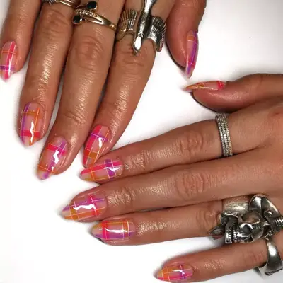 Jelly plaid manicure in pink, orange, purple, and white.