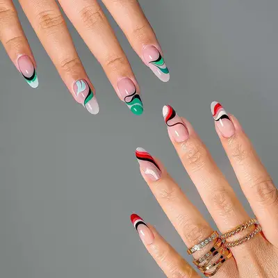 Green (upper left corner) and red (lower right corner) swirl manicures