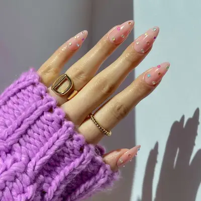 a neutral bejeweled manicure