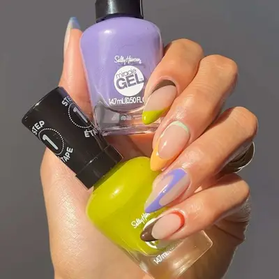 a negative space manicure in multiple shades