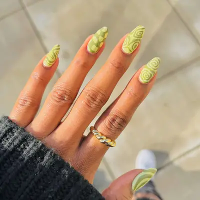 a mismatched manicure in shades of matcha and sage