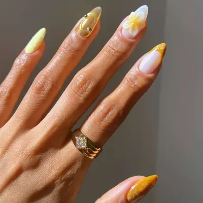a soft butter yellow mismatched manicure