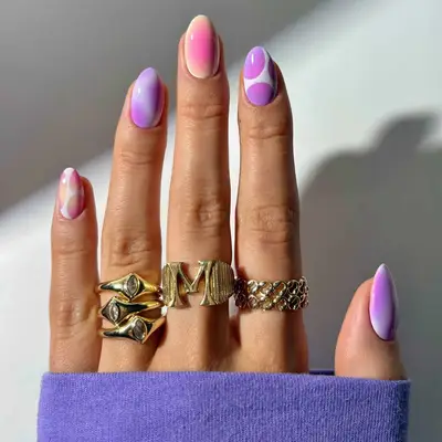 an ombré manicure in shades of purple with lava lamp designs