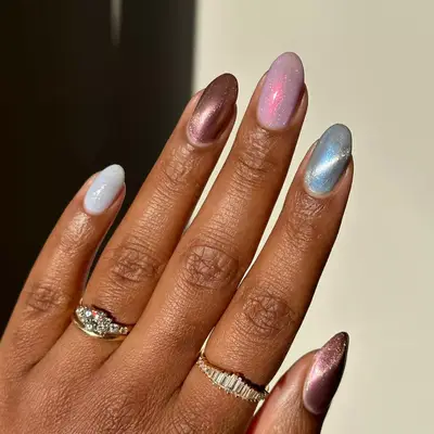Model with metallic nails in brown, pink, and blue