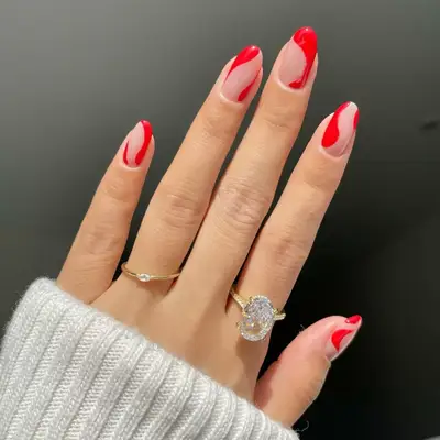 Model with taupe nails with red swirls