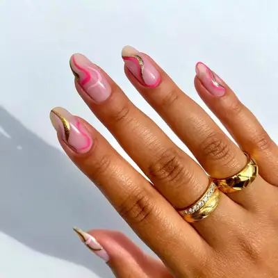 model with light pink nails with pink, gold, and fuchsia waves