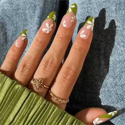 green french tips with white daisy flower design and rhinestone accent