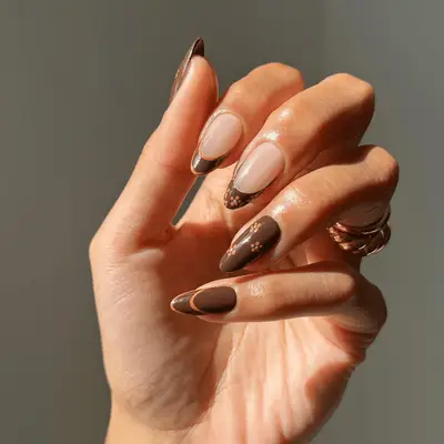 chocolate brown french tips with orange daisy floral design and orange trim