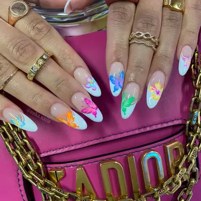 white french tips with colorful flower and butterfly designs