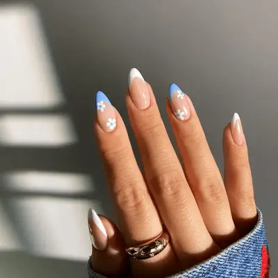 alternating blue and white french tips with daisy flower accents