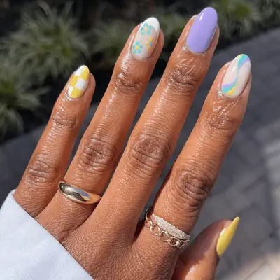 purple, yellow, and blue mismatched manicure