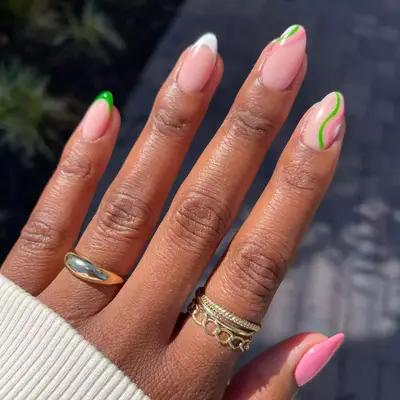 Pink, green and white manicure with French tips and swirls