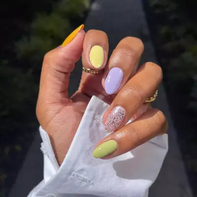 Pastel Skittle nails with one glitter party nail