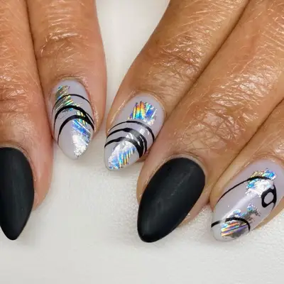 Iridescent rainbow nails with black lines on top and solid matte, black nails
