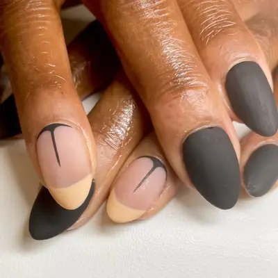 Matte black nails with beige French tip accents