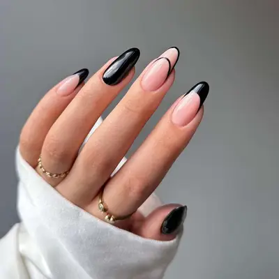 Rounded, almond nails with accented and solid black lines