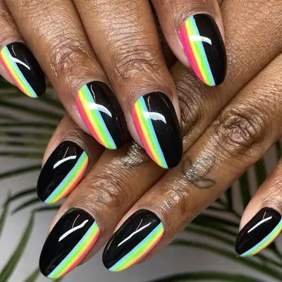 Pastel rainbow stripes on black almond-shaped nails