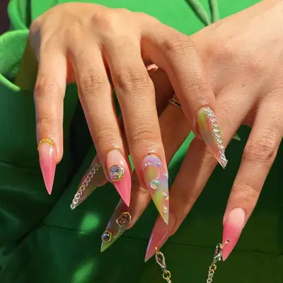 Multicolor stiletto nails with gemstone and chain accents
