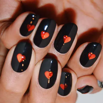 Half-matte, half-glossy manicure with black base and red heart design