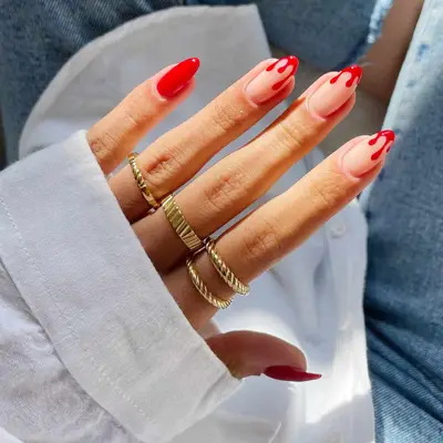 Red manicure with blood drip French tips