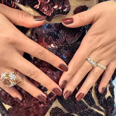 Selena Gomez wearing Dark shimmery short nails