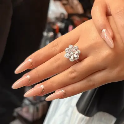 Arianna Greenblatt wearing long French manicure with silver flower ring