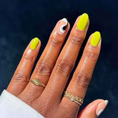 Lemon lime nails with a black, white, and gray swirl ring finger and thumb - MYM Beauty Festival Nails