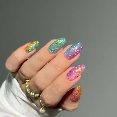 Shade-shifting rainbow jelly nails with terrazzo chrome accents - MYM Beauty Festival Nails