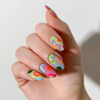 Round nails with multicolor abstract blob nail art - MYM Beauty Festival Nails